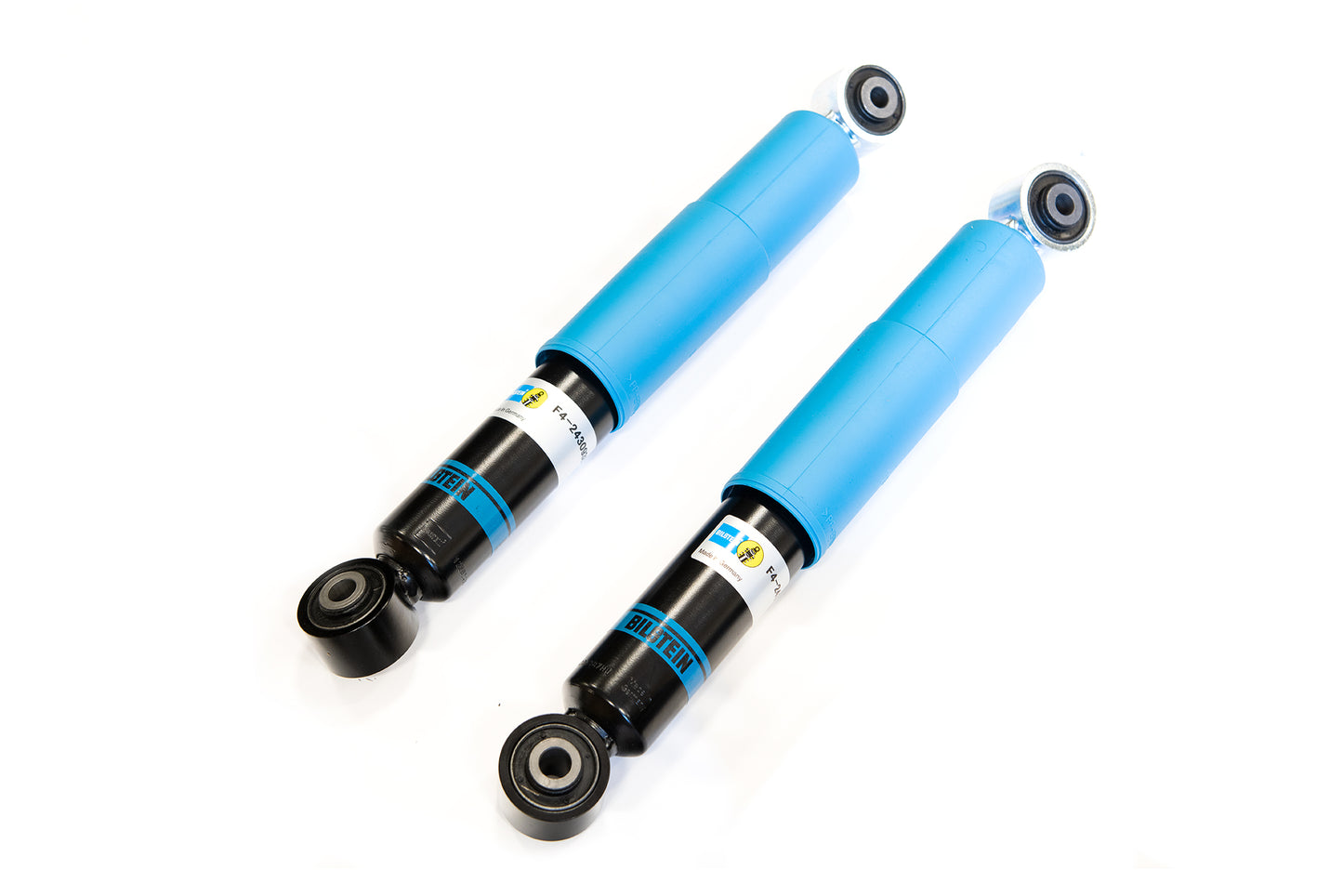Two automotive shock absorbers with blue cylinders and black bases, designed for dampening vehicle suspension.