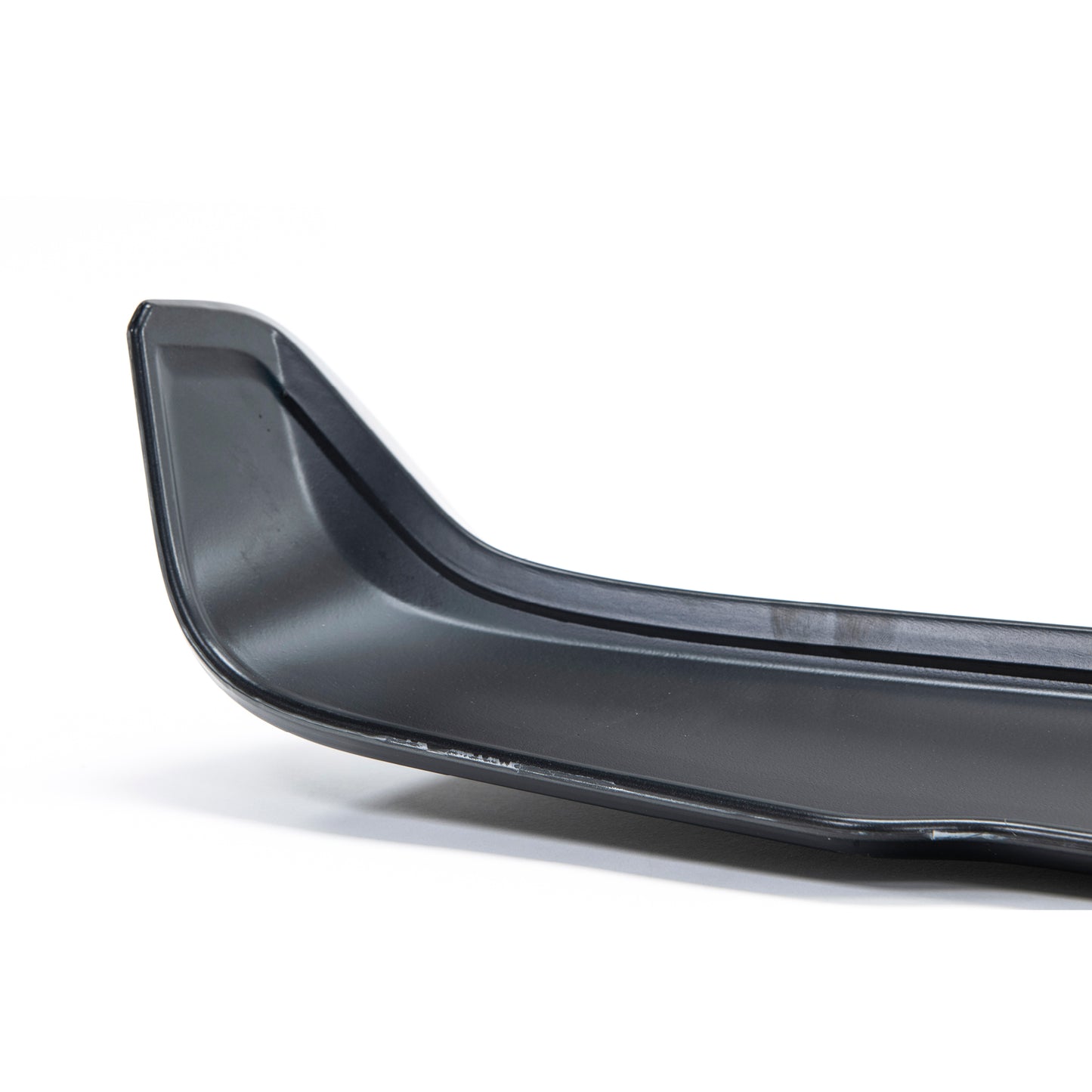 Close-up of a sleek, black car spoiler, showcasing its curved design and smooth surface, set against a white background.