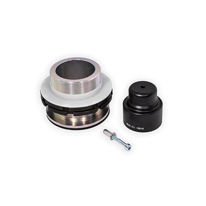 Image of a mechanical assembly featuring a shiny, metal component with grooves, a black cylindrical part, and a small bolt.